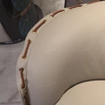 Cream Curved Leather Sofa with Dark Green Fan-Stitched Panels and Laced Edge Details